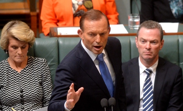 Tony Abbott is trying to switch the focus from a Qantas debt guarantee to the repeal of the carbon tax. AAP/Alan Porritt